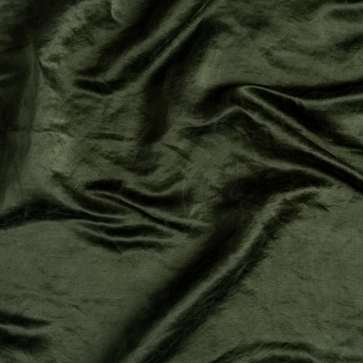 Close-up of Bella Notte Paloma pillowcase in Juniper, showing draped linen fabric texture.