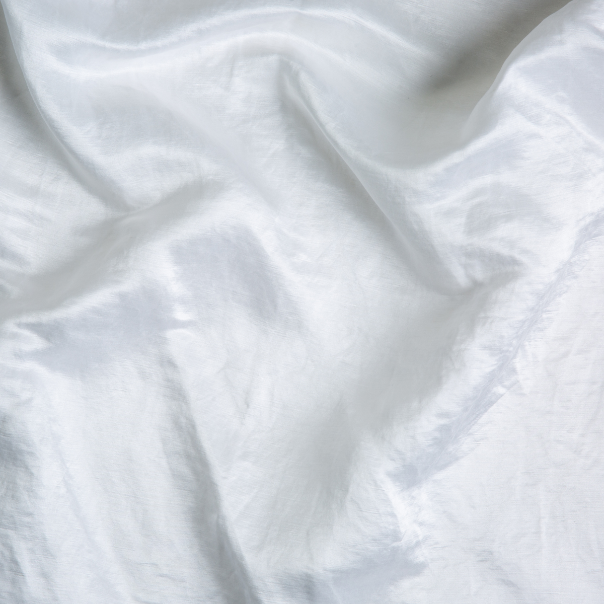 Bella Notte Paloma pillowcase in White, draped linen fabric with soft natural creasing.