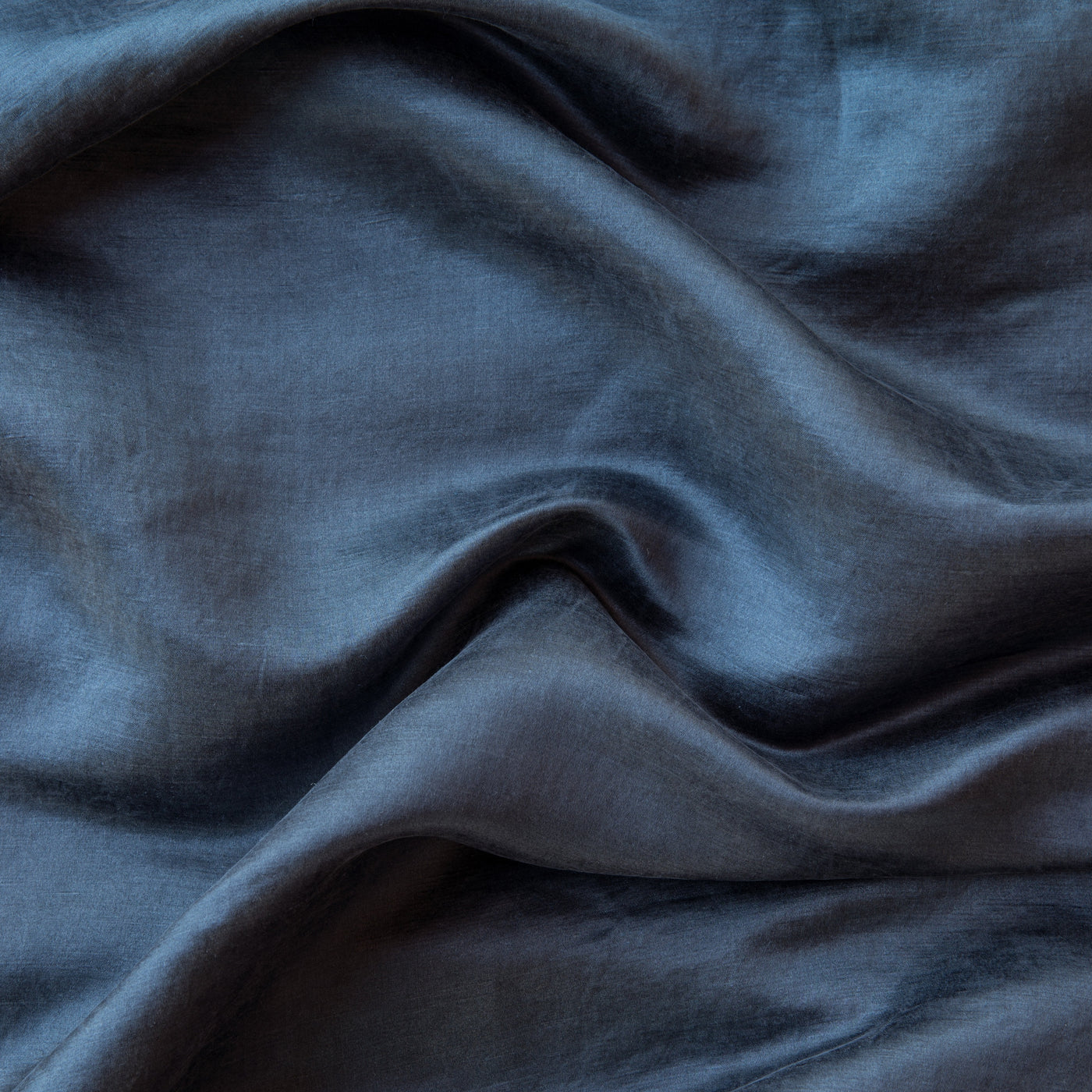 Close-up of Midnight Paloma fabric showing soft drape and subtle sheen of silk-blend weave.