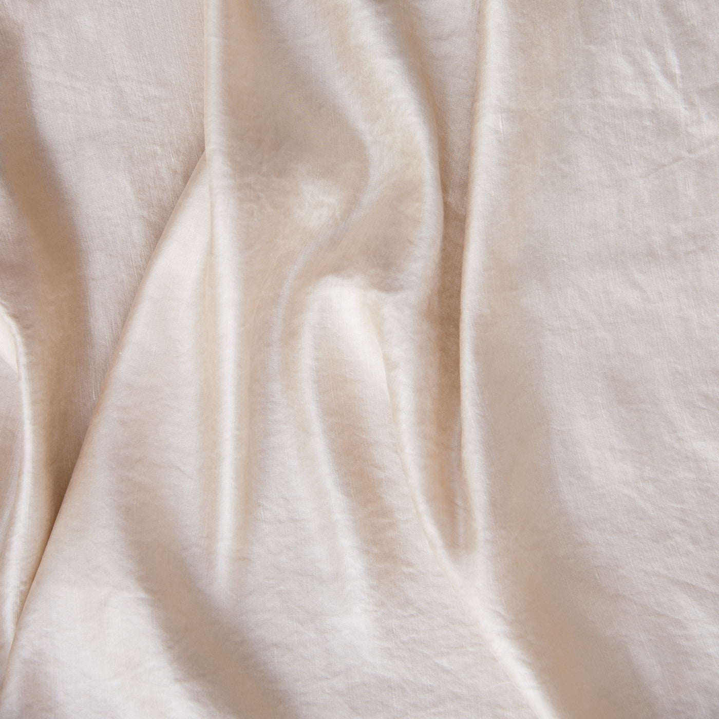 Close-up of Bella Notte Paloma sham in Pearl, showing soft draped linen fabric texture.