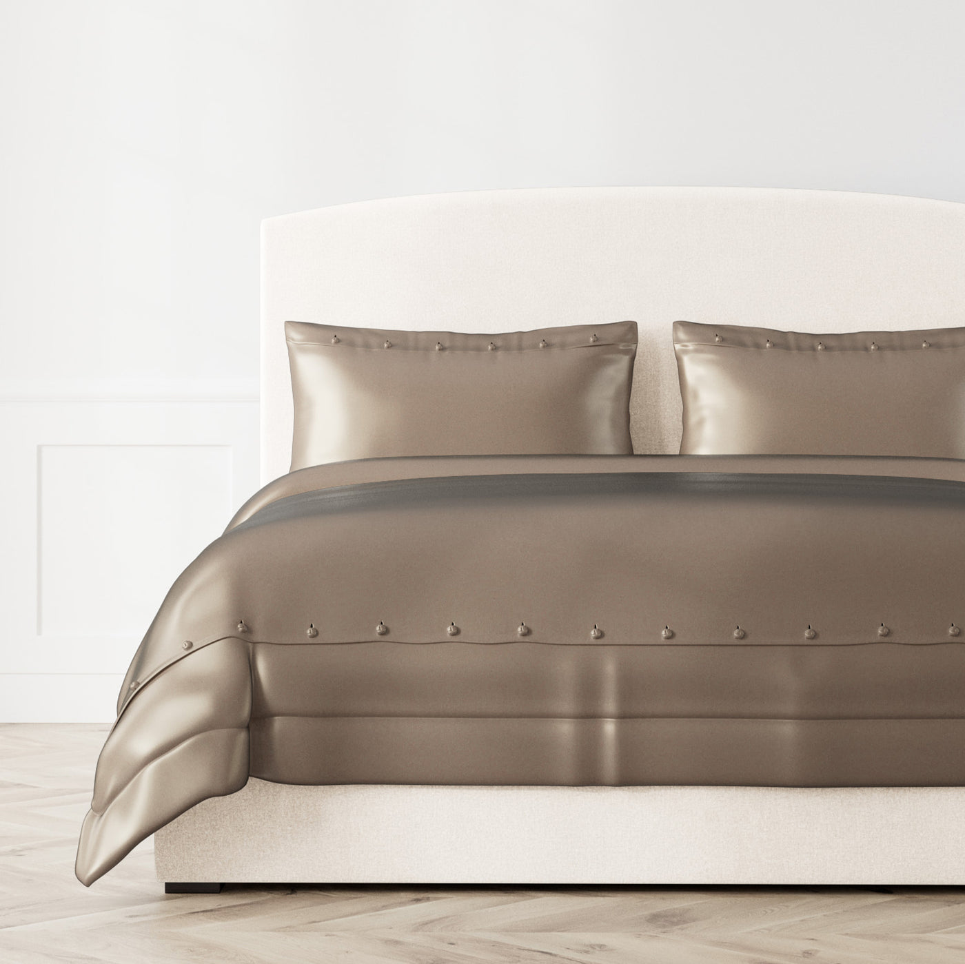 Ann Gish Charmeuse duvet cover in taupe with button detail, styled on bed with matching shams.