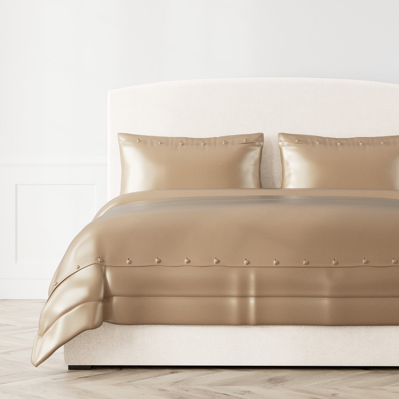 Champagne silk charmeuse duvet cover with satin button trim, styled on a made bed.