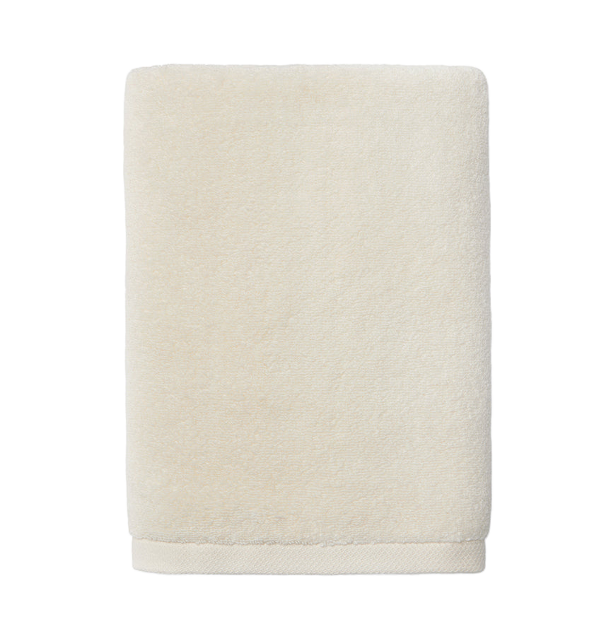 Sferra Cielo ivory cotton terry hand towel, folded flat.