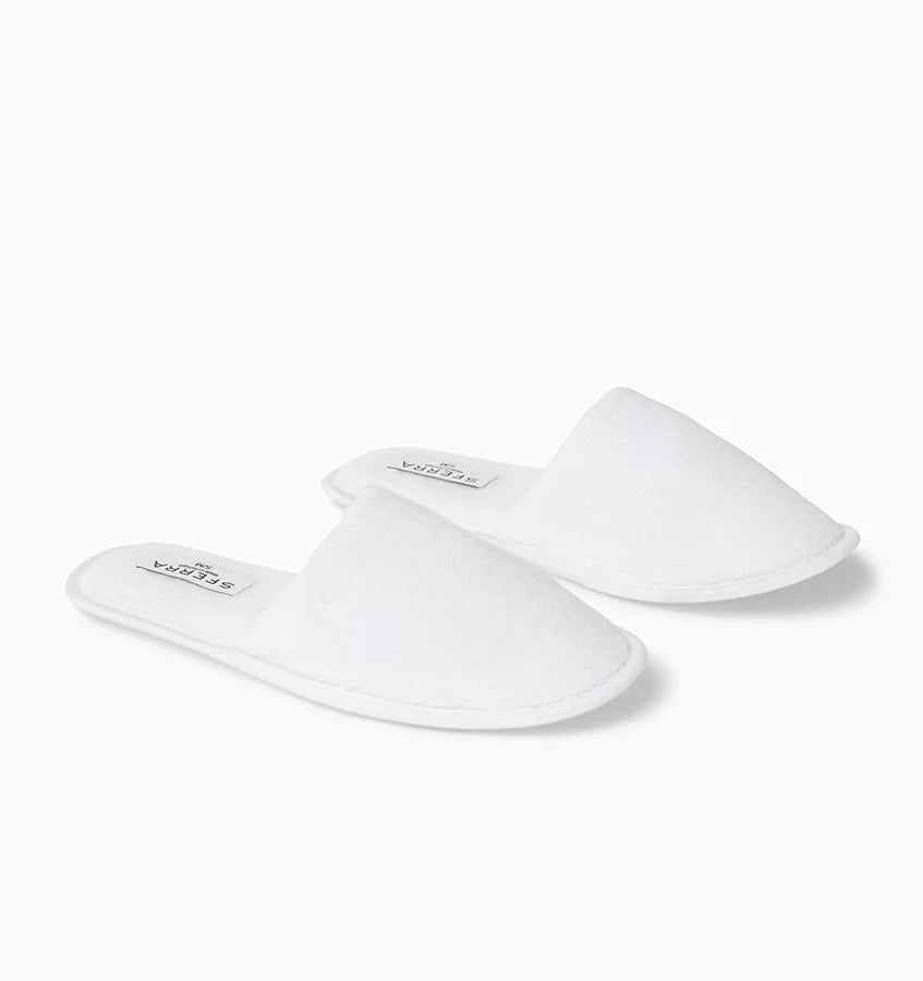 Pair of white slippers on a white background