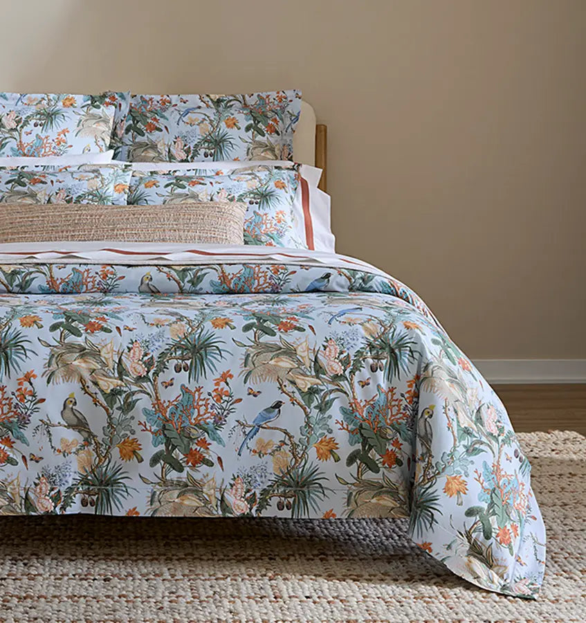 Bed styled with Cinque Terra duvet, showing full tropical botanical print with birds.