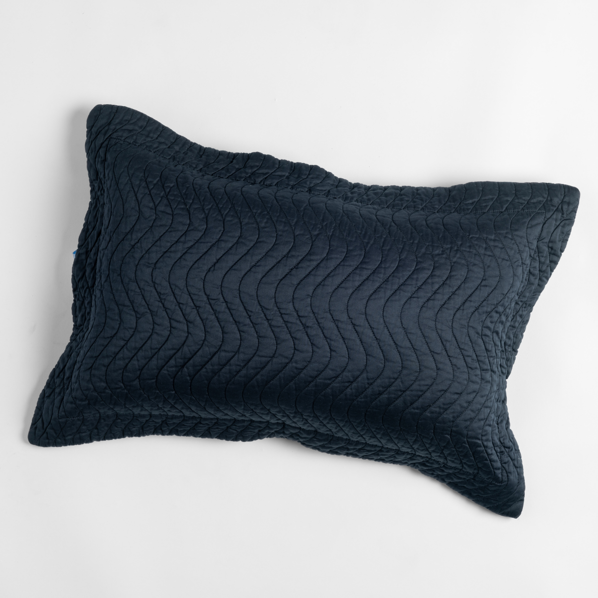 Bella Notte Cirillo pillow sham in Slate with wave quilting detail, angled view.