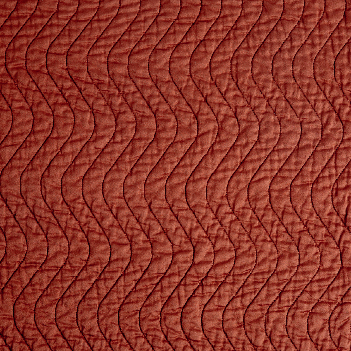 Close-up of Autumn Bella Notte Cirillo coverlet showing wave quilting pattern.