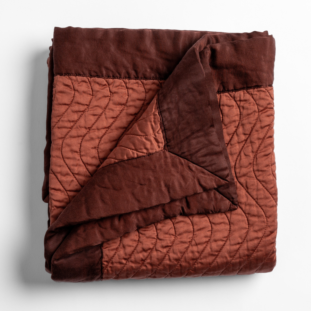 Bella Notte Cirillo blanket folded, showing Autumn quilted face and dark velvet reverse.