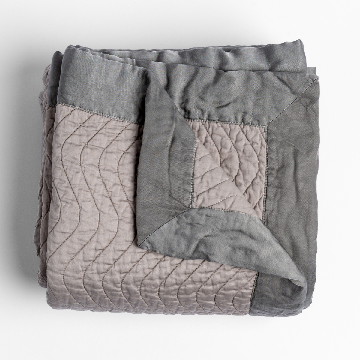 Bella Notte Cirillo blanket in Fog, folded to show wave-quilted stitching and two-tone reverse.
