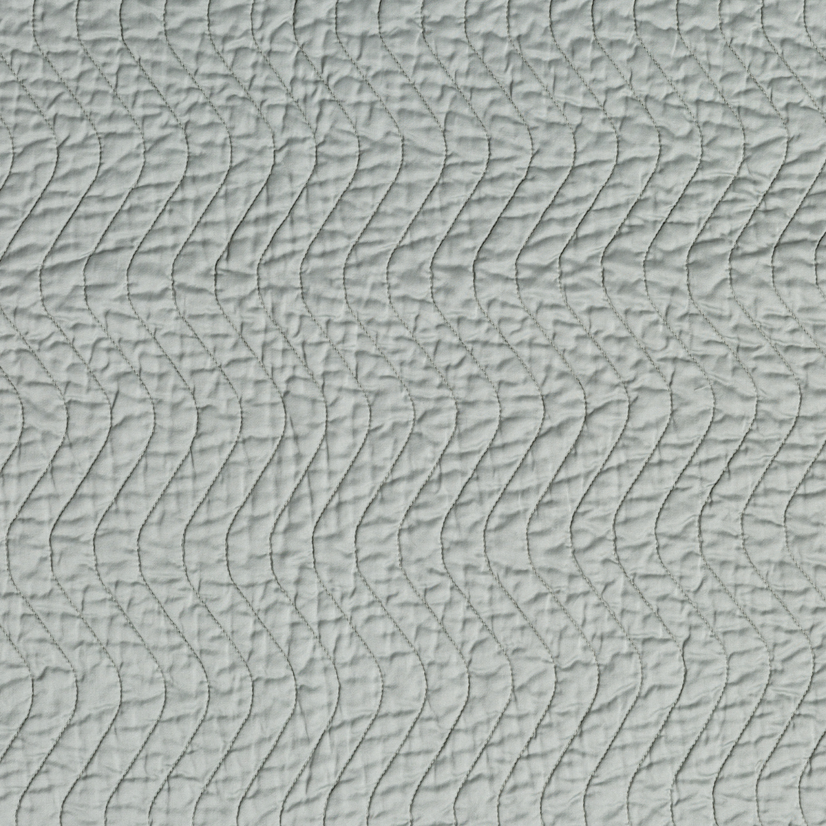 Close-up of Eucalyptus quilted fabric with flowing wave stitch pattern on Cirillo sham.