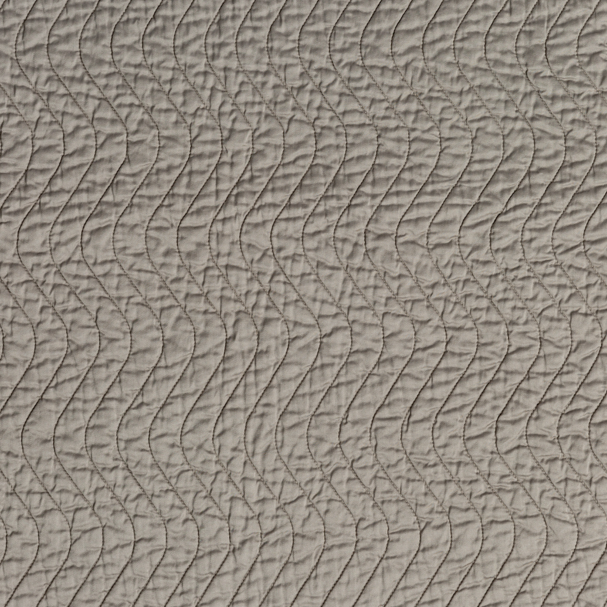 Close-up of Fog Bella Notte Cirillo sham showing wave-quilted texture in muted taupe.