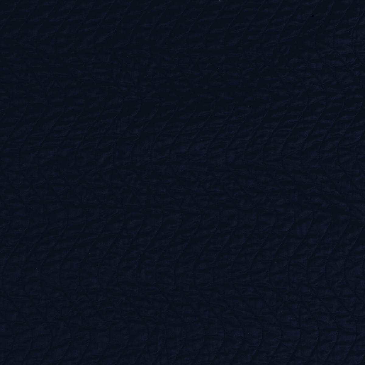 Close-up of Cirillo coverlet in Midnight, showing deep navy textured weave detail.