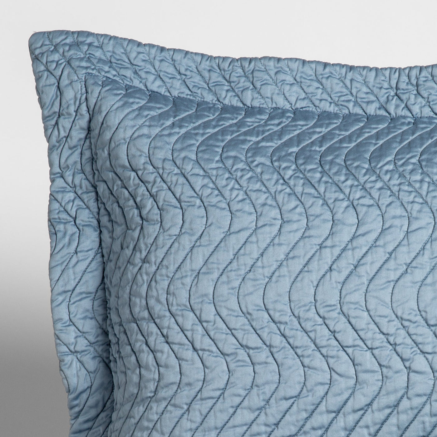 Close-up of Bella Notte Cirillo throw pillow in Tahoe Blue with wave quilted texture.