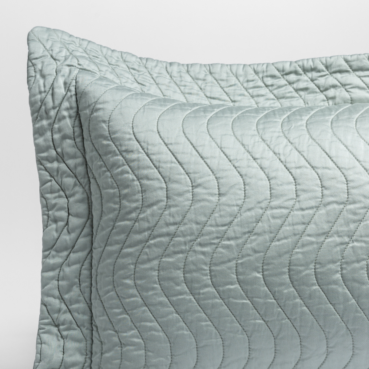 Close-up of Eucalyptus sham with wave quilting pattern and flanged edge.