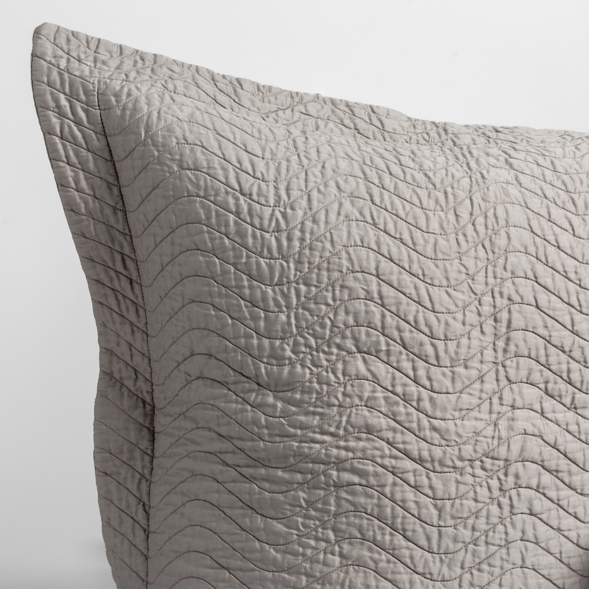 Close-up of Bella Notte Cirillo sham in Fog, showing wave-quilted texture detail.