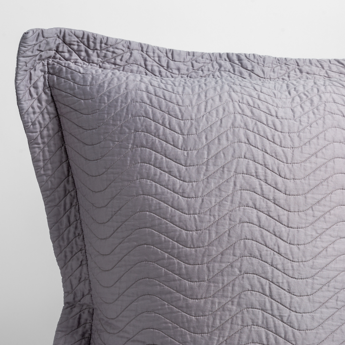 Close-up of Bella Notte Cirillo sham corner in French Lavender with wave quilting detail.