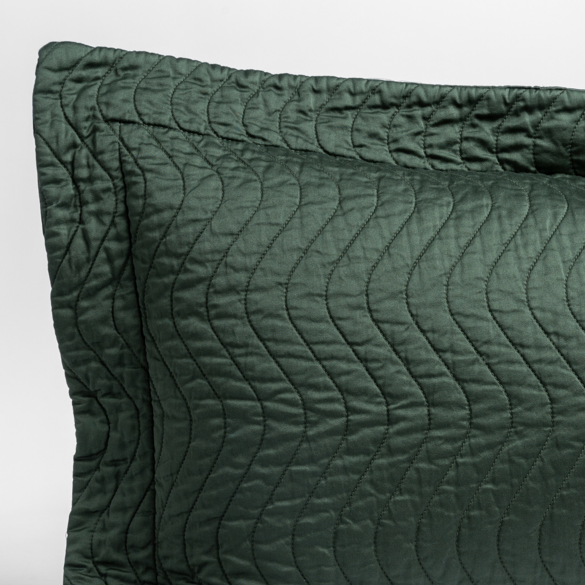 Close-up of Juniper quilted Bella Notte Cirillo pillow sham corner with wave stitching.