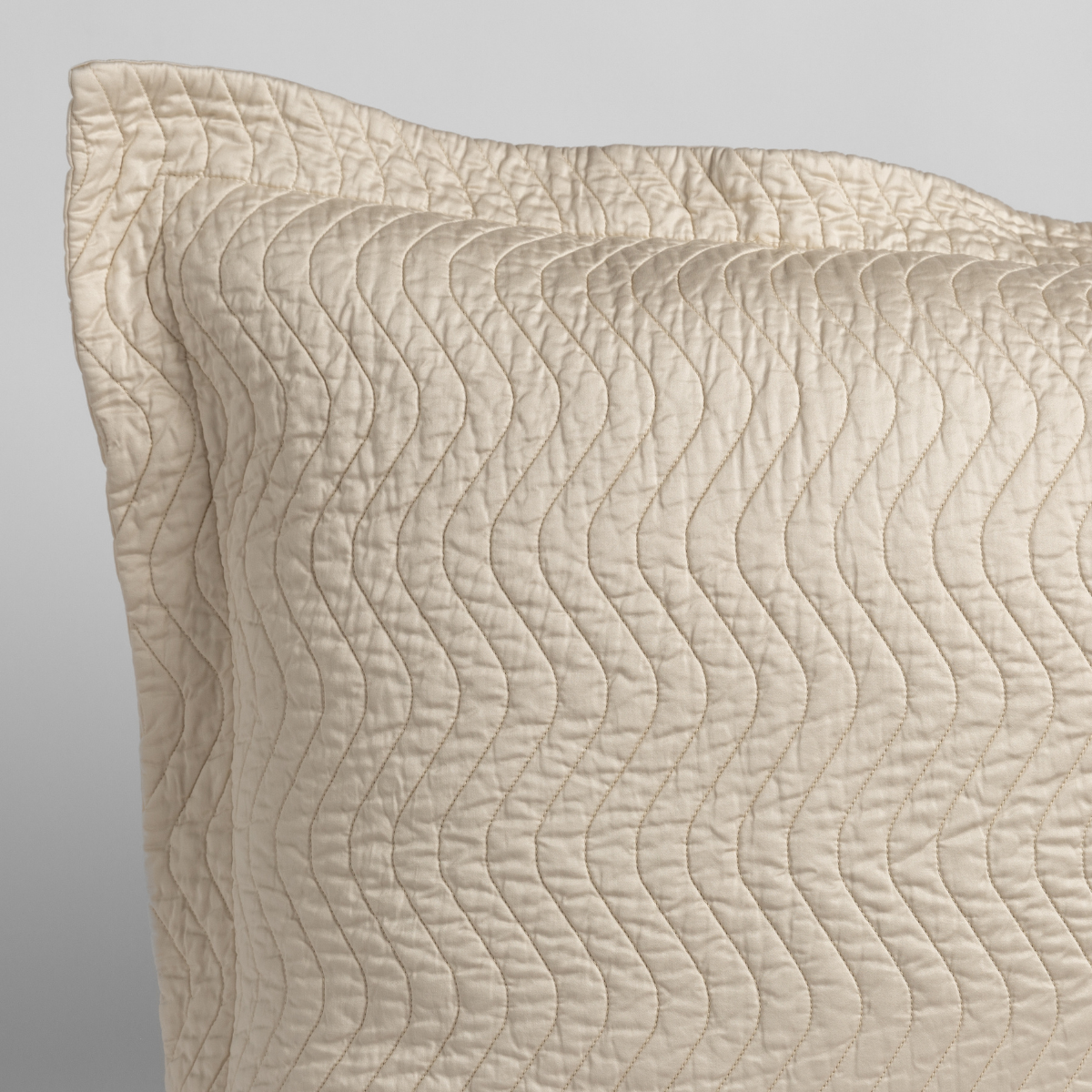 Close-up of Bella Notte Cirillo throw pillow corner showing wave-stitched quilting detail.