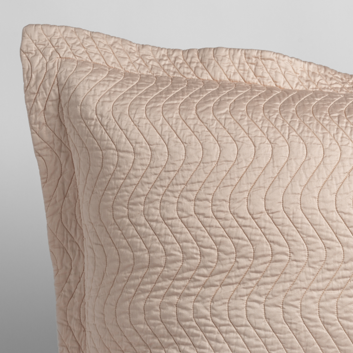 Close-up of Pearl Bella Notte Cirillo throw pillow corner, wave-stitched quilted texture.