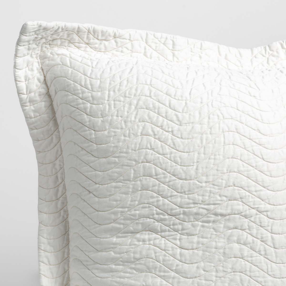 Close-up of Bella Notte Cirillo sham corner in Winter White with wave quilting detail.