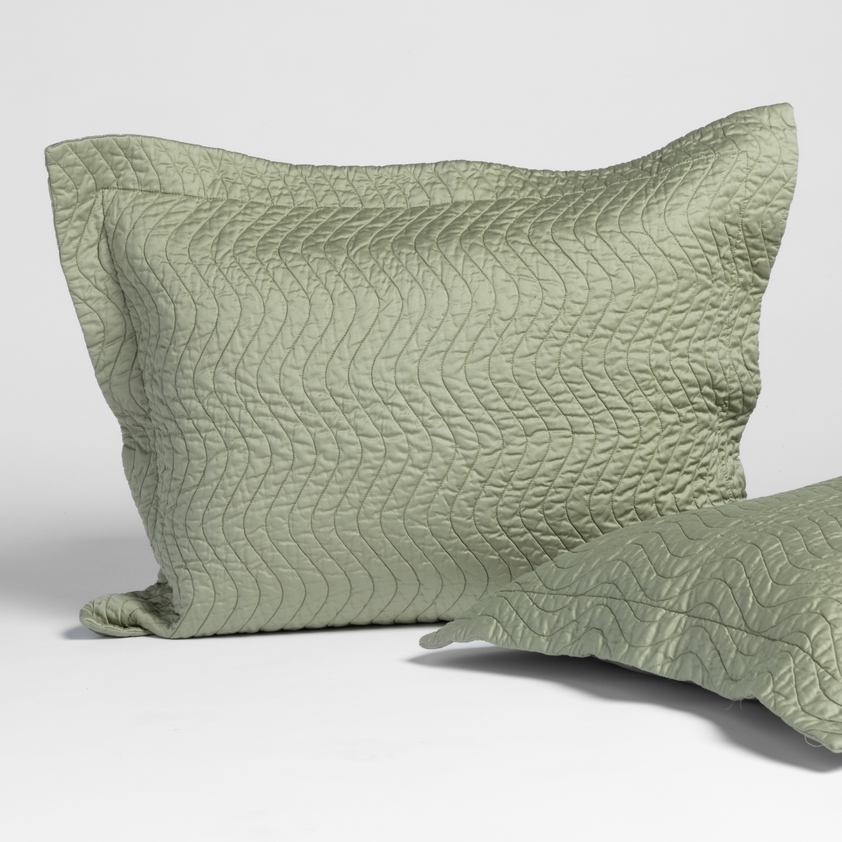 Bella Notte Cirillo sham in Desert Sage with wave quilting detail, flanged edge.