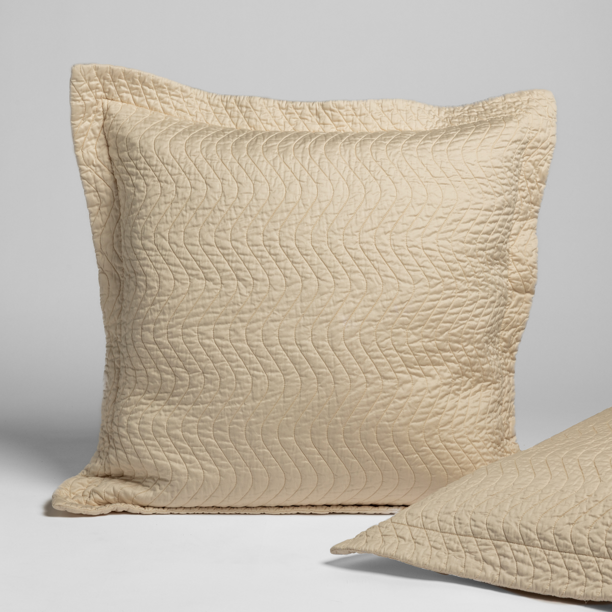 Bella Notte Cirillo sham in Natural, quilted texture with flanged edge, second sham visible behind.