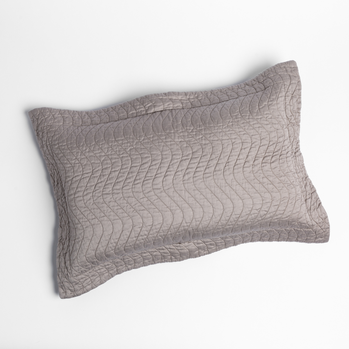 Bella Notte Cirillo pillow sham in Fog, wave-quilted silk on white background.
