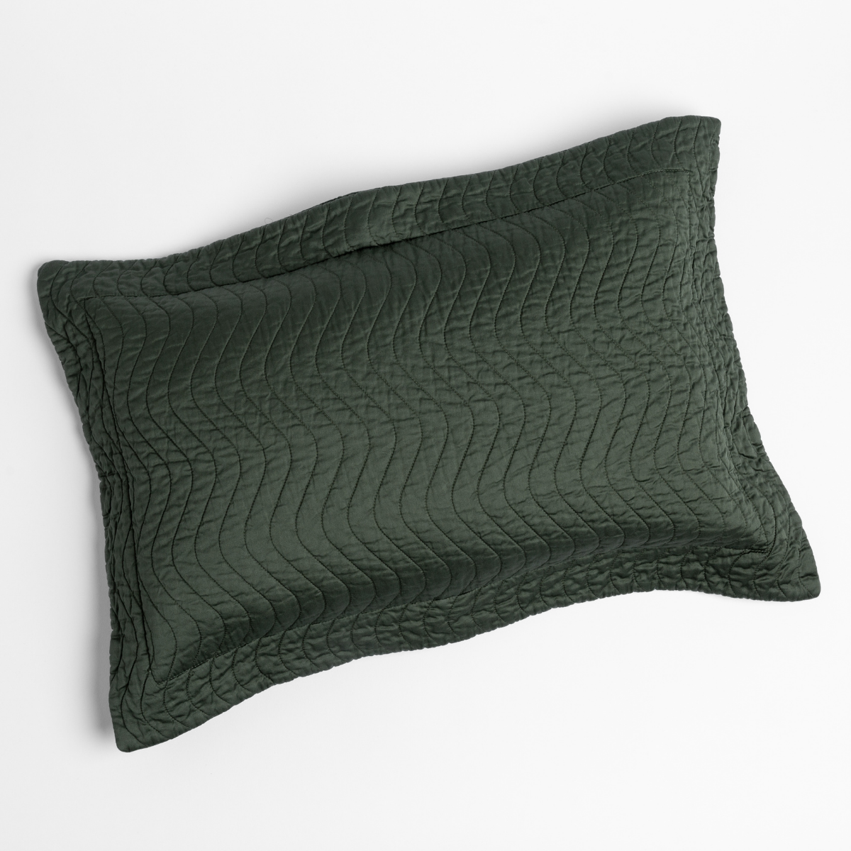 Juniper quilted pillow sham with wave-pattern stitching, angled view on white background.