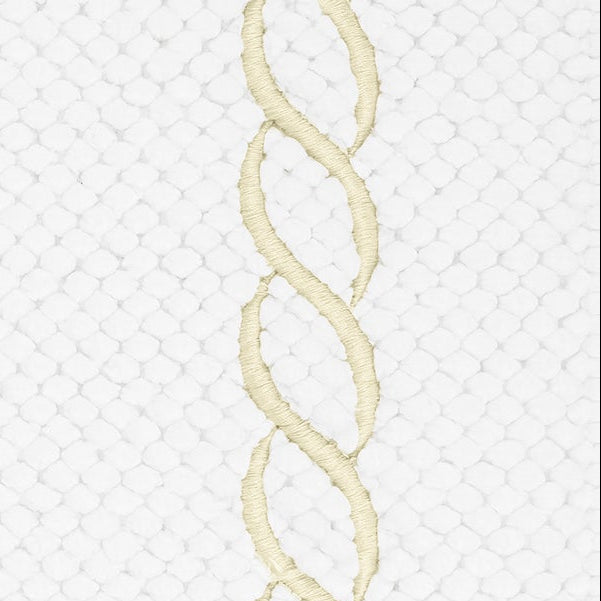 Close-up of ivory embroidered chain motif on white waffle-weave cotton tub mat.