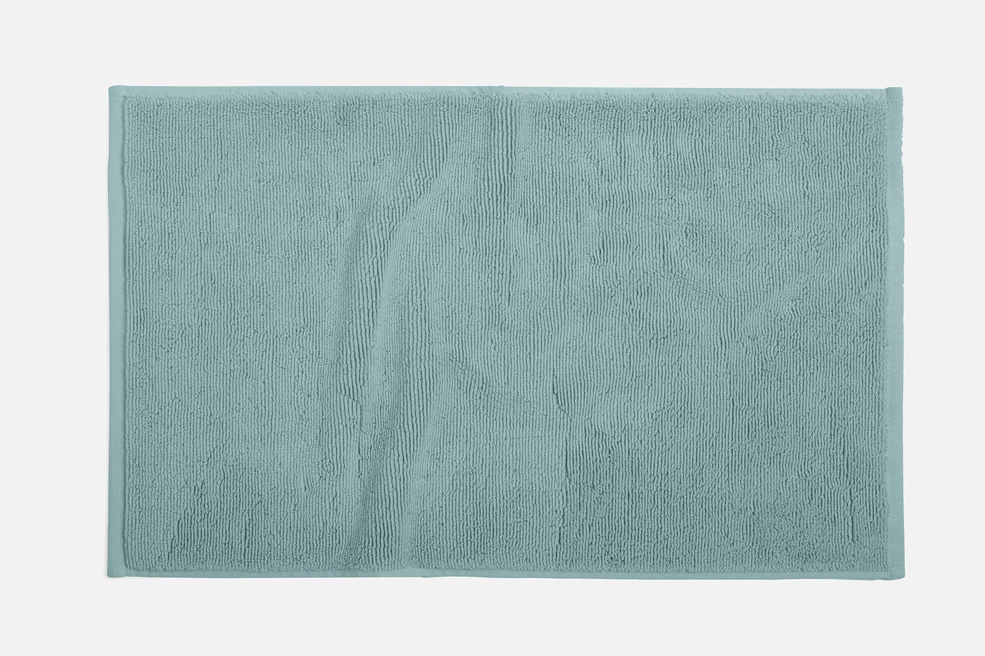 Coyuchi Cloud Loom bath rug in seafoam, flat lay showing plush terry texture and border detail.