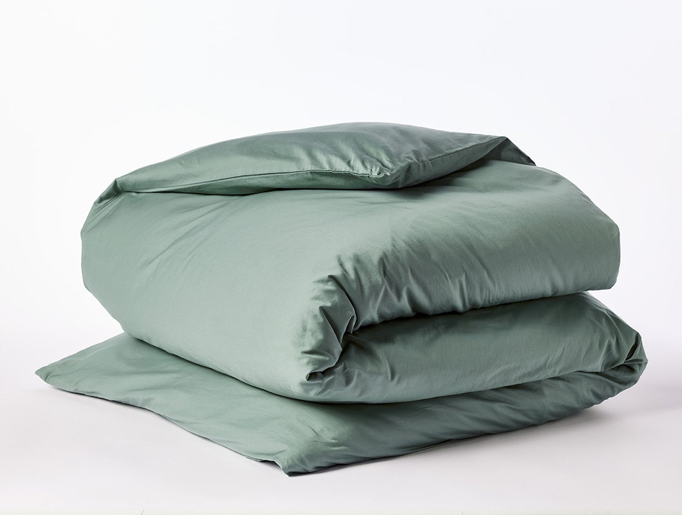 Coyuchi Cloud Soft Sateen duvet cover folded neatly, sage green sateen finish.
