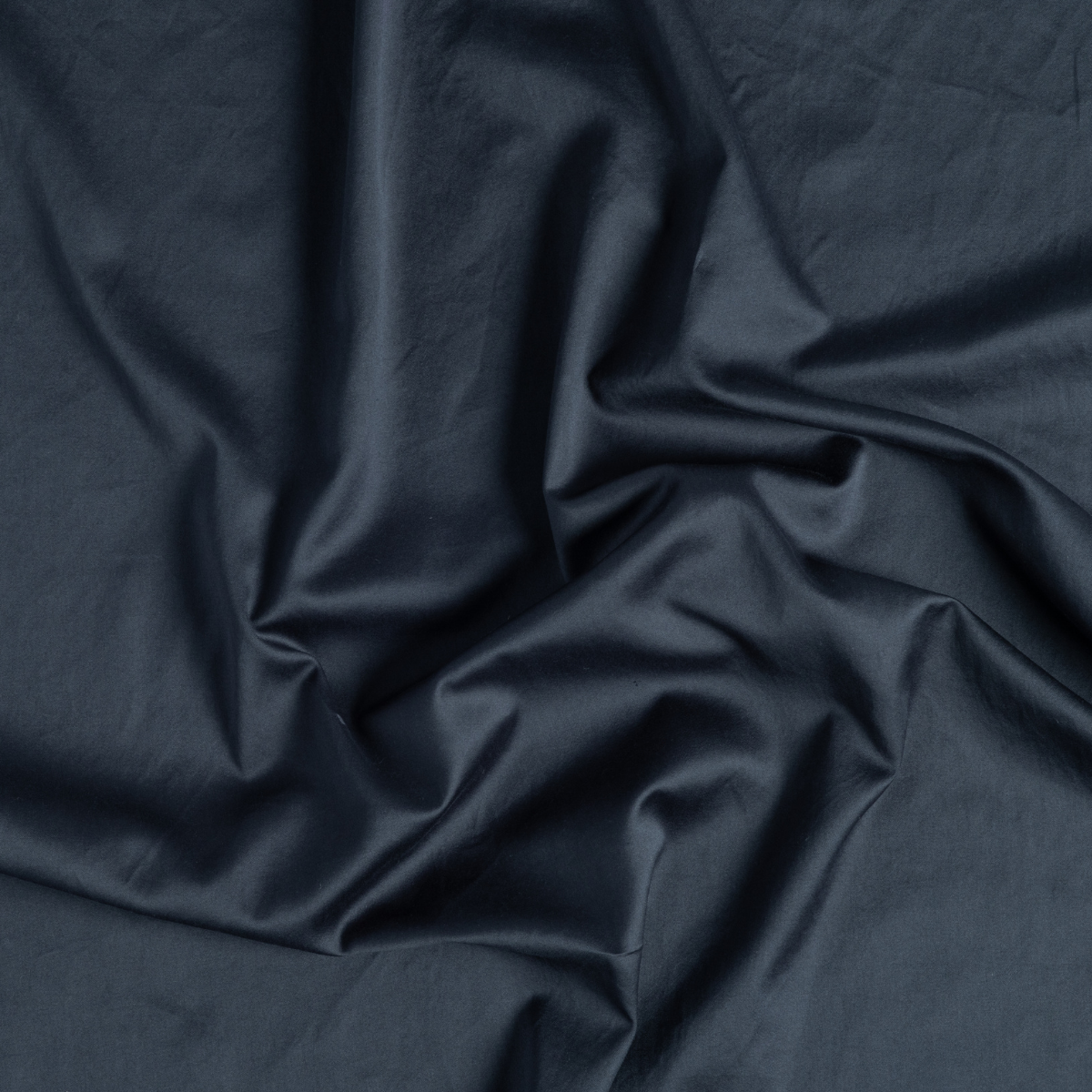 Slate fitted sheet fabric close-up showing smooth cotton drape and subtle sheen.
