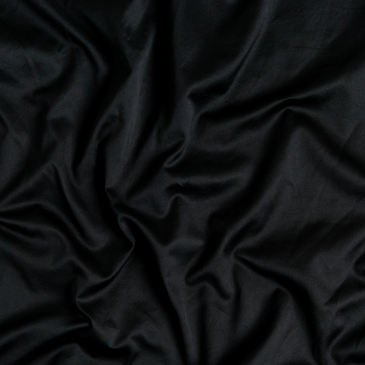 Close-up of Bella Notte Bria pillowcase in Corvino, showing smooth fabric drape and sheen.