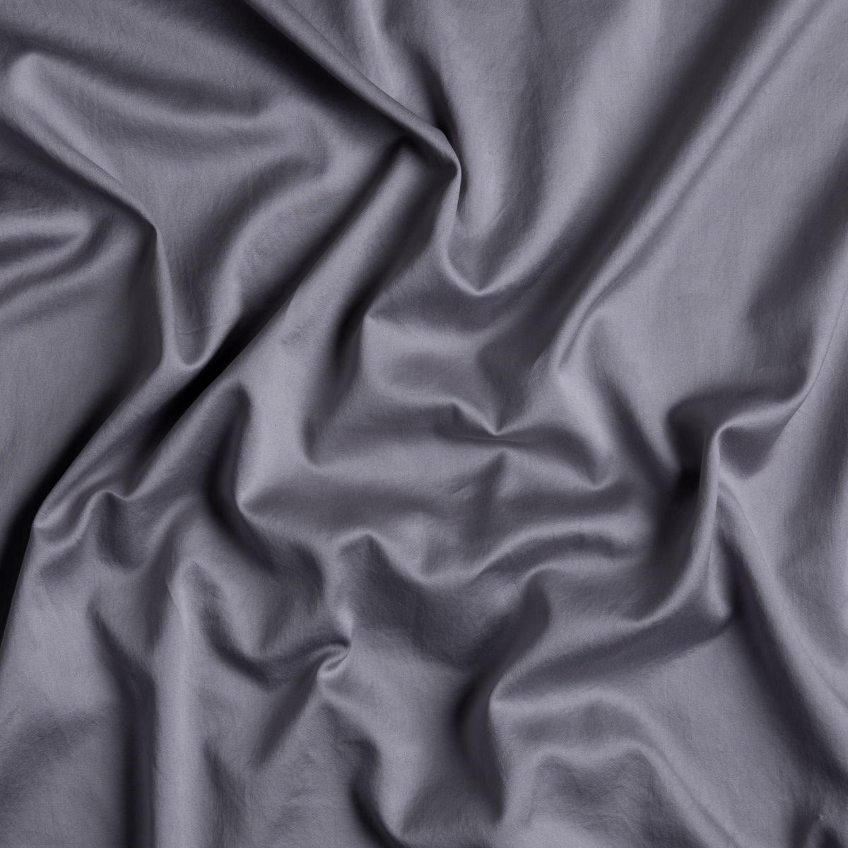 Close-up of French Lavender Bella Notte Bria fitted sheet fabric, showing smooth sateen drape.