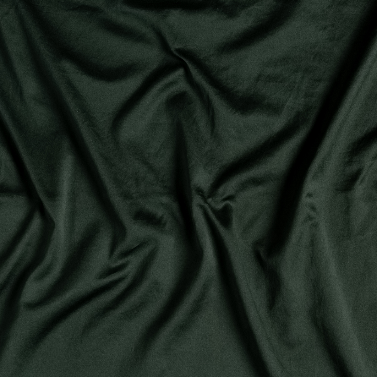 Close-up of Juniper Bria fitted sheet fabric, showing soft drape and smooth texture.