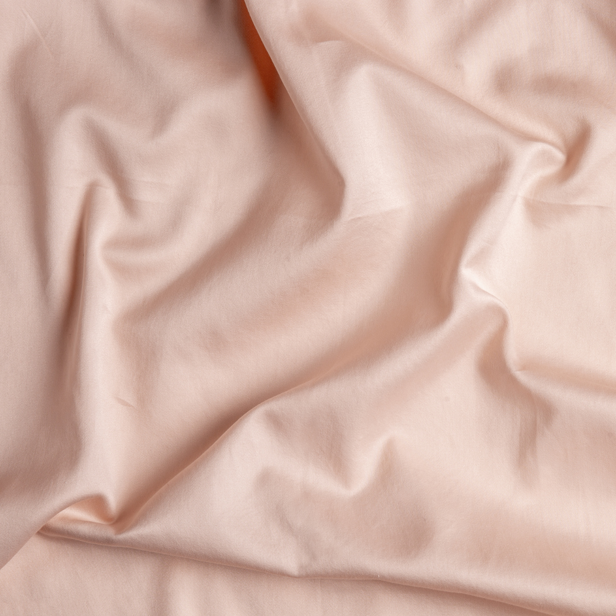 Softly draped Pearl fabric close-up showing smooth sateen weave and gentle folds.