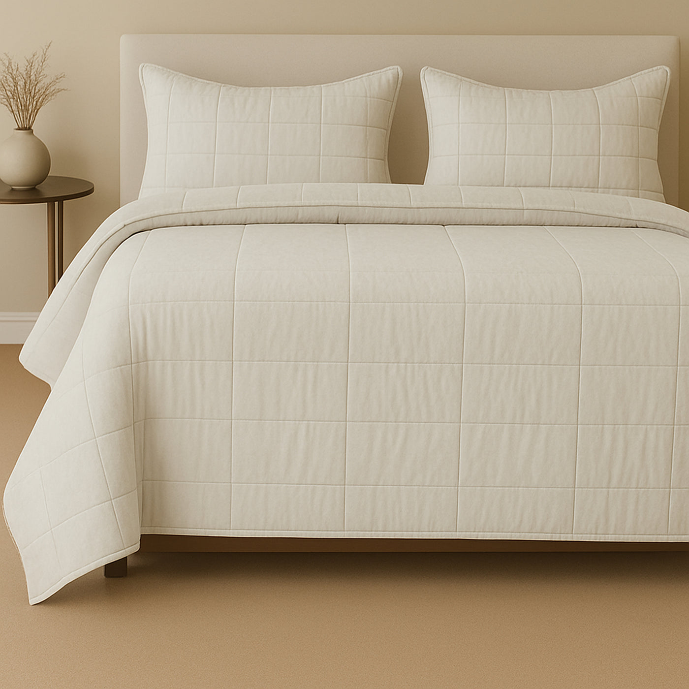 Ivory cotton canvas coverlet set with grid quilting, styled on a bed with matching shams.