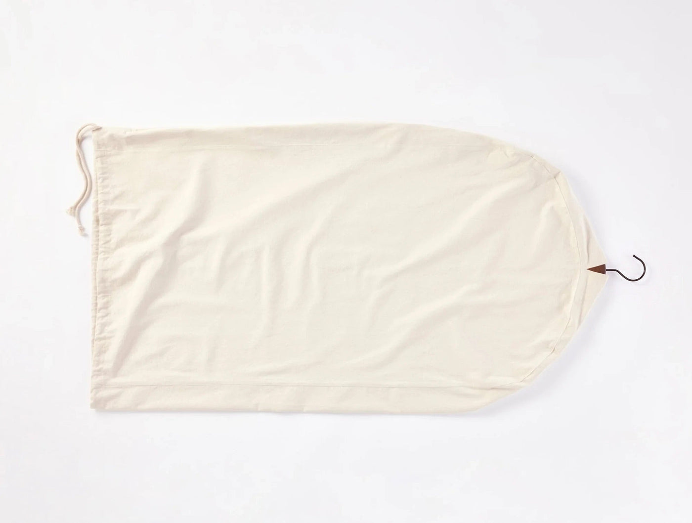 Coyuchi Conserve ivory cotton garment bag with drawstring closure and metal hook.