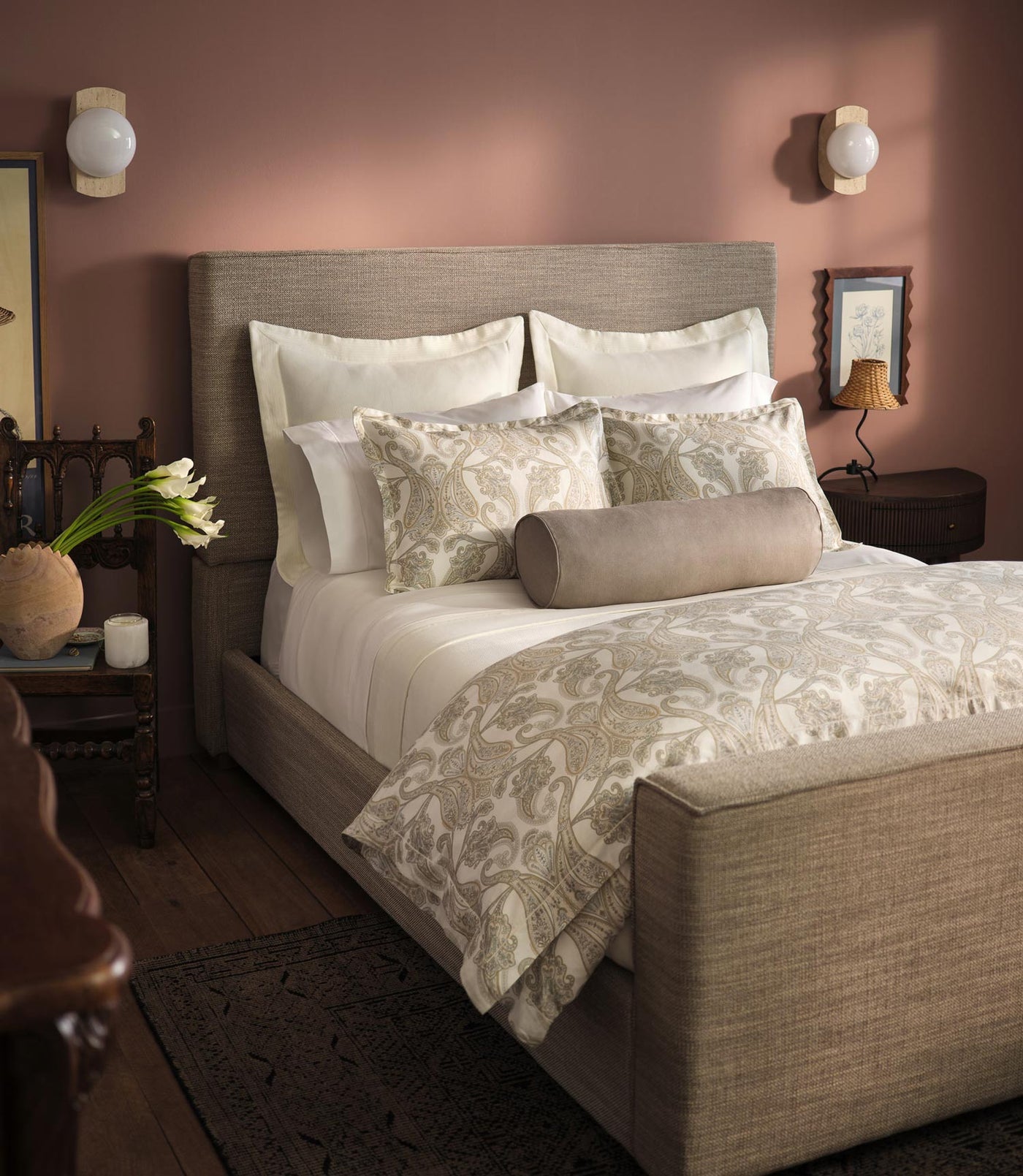 Paisley Pearl duvet styled on upholstered bed, warm rose-walled bedroom with coordinating shams.