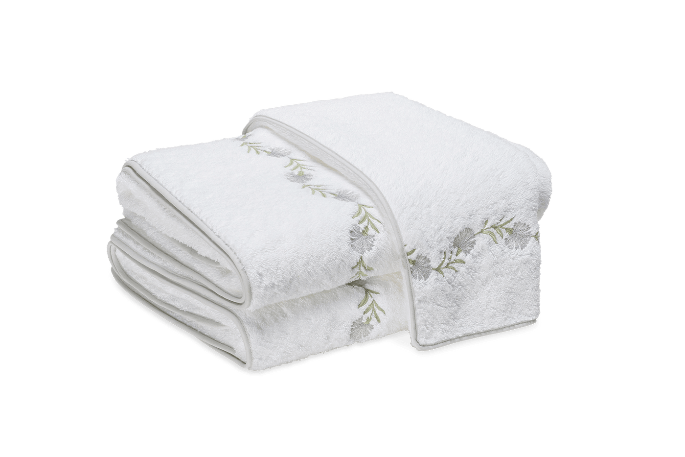 Matouk Daphne white terry guest towels with sage green floral embroidered border, stacked.