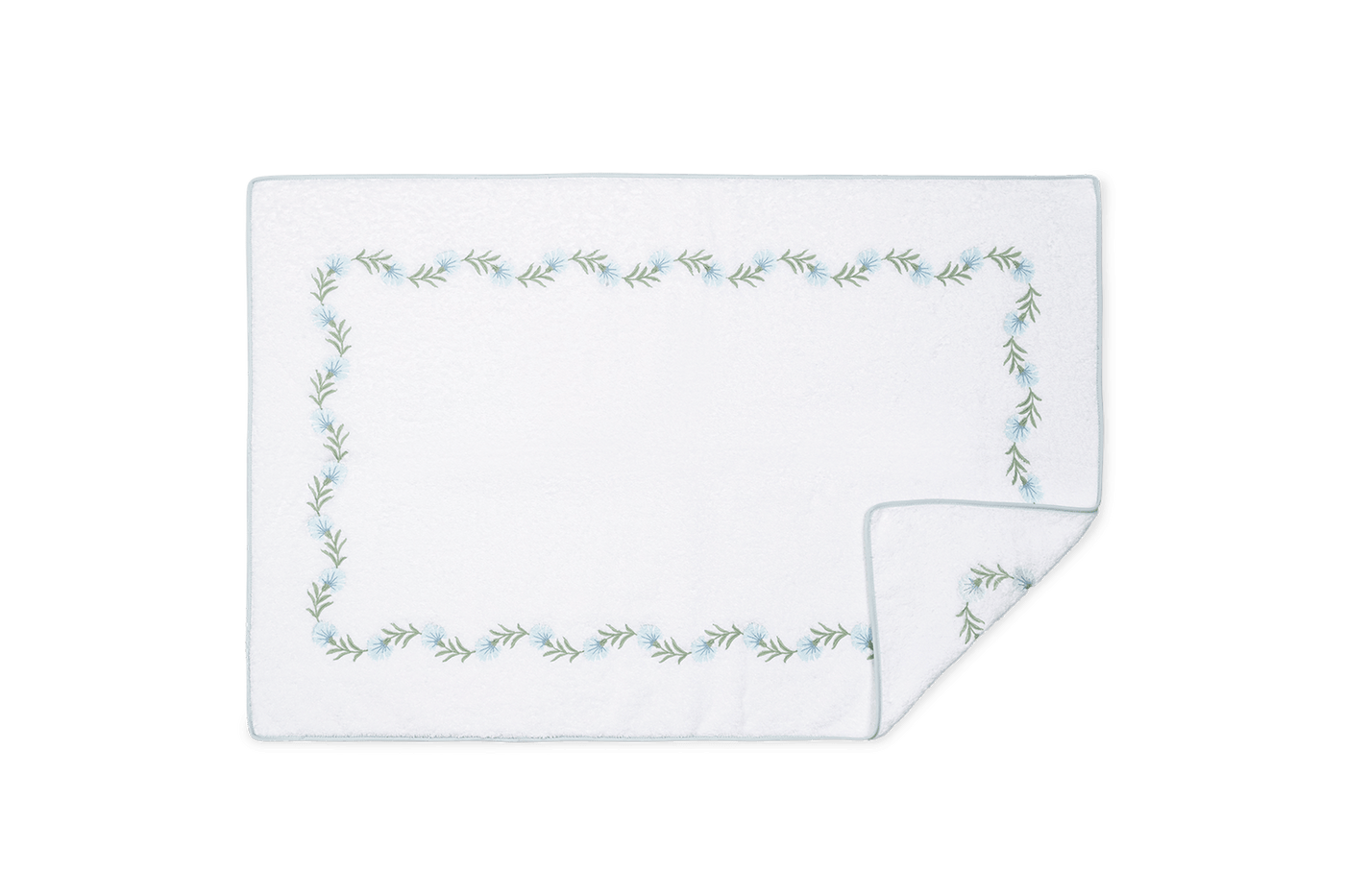 Corner detail of Matouk Daphne tub mat showing embroidered botanical vine border.