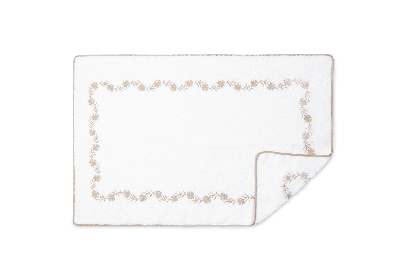 Corner detail of Matouk Daphne tub mat showing taupe floral vine embroidery border.