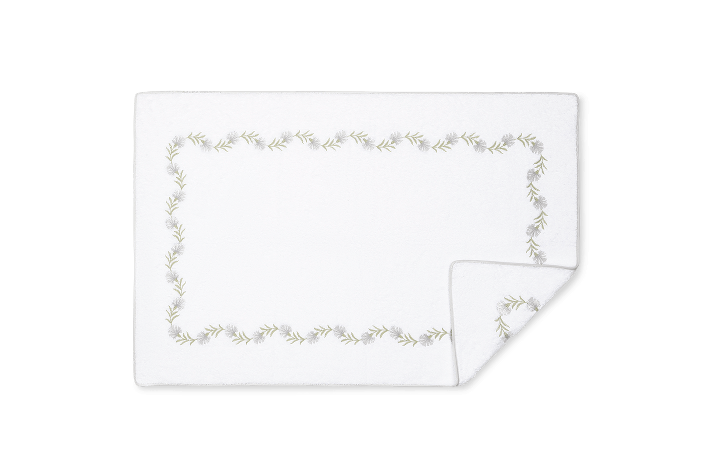 Corner detail of Matouk Daphne tub mat showing sage floral vine embroidery border.