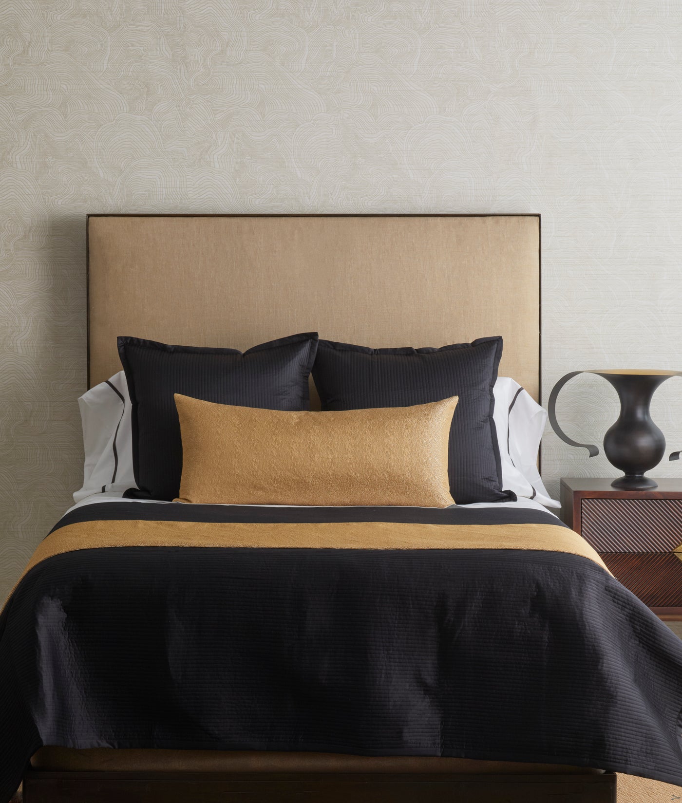 Champagne and charcoal bed finisher set styled on a made bed with matching shams.
