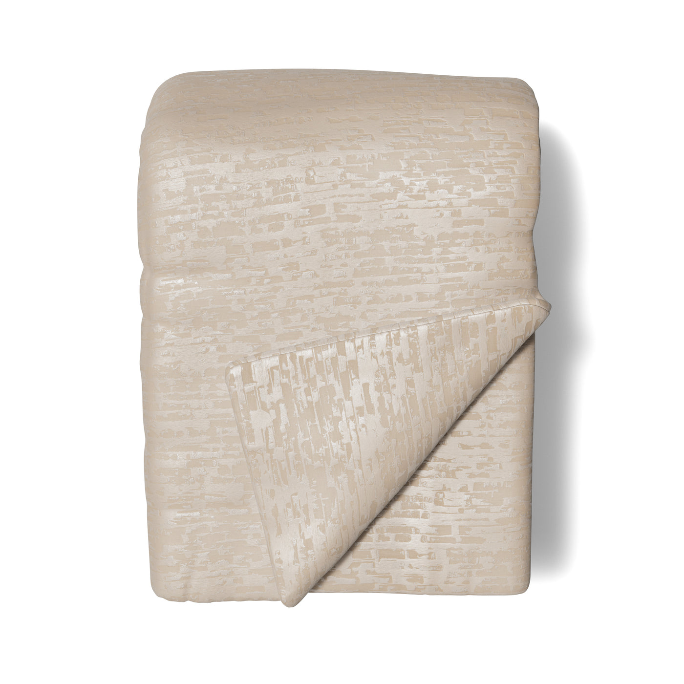Close-up of Ann Gish Delphi throw folded, ivory jacquard with subtle geometric sheen.