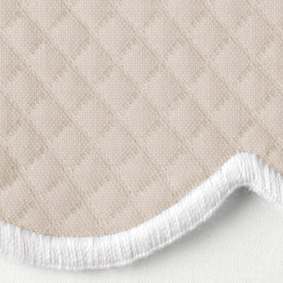 Close-up of sand diamond piqué weave with curled white terry reverse edge detail.