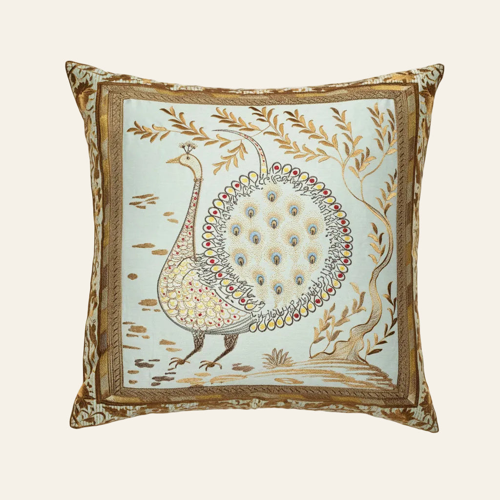 Ann Gish Divani cushion in celadon with embroidered peacock and gold botanical border.