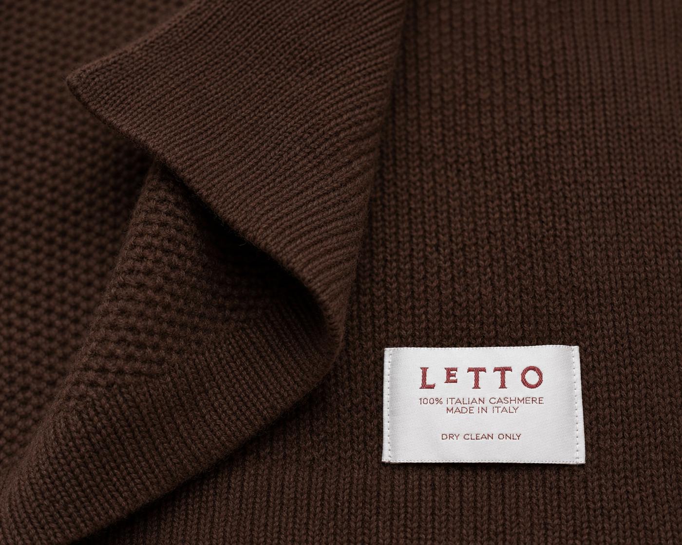 LETTO label on brown knitted blanket.