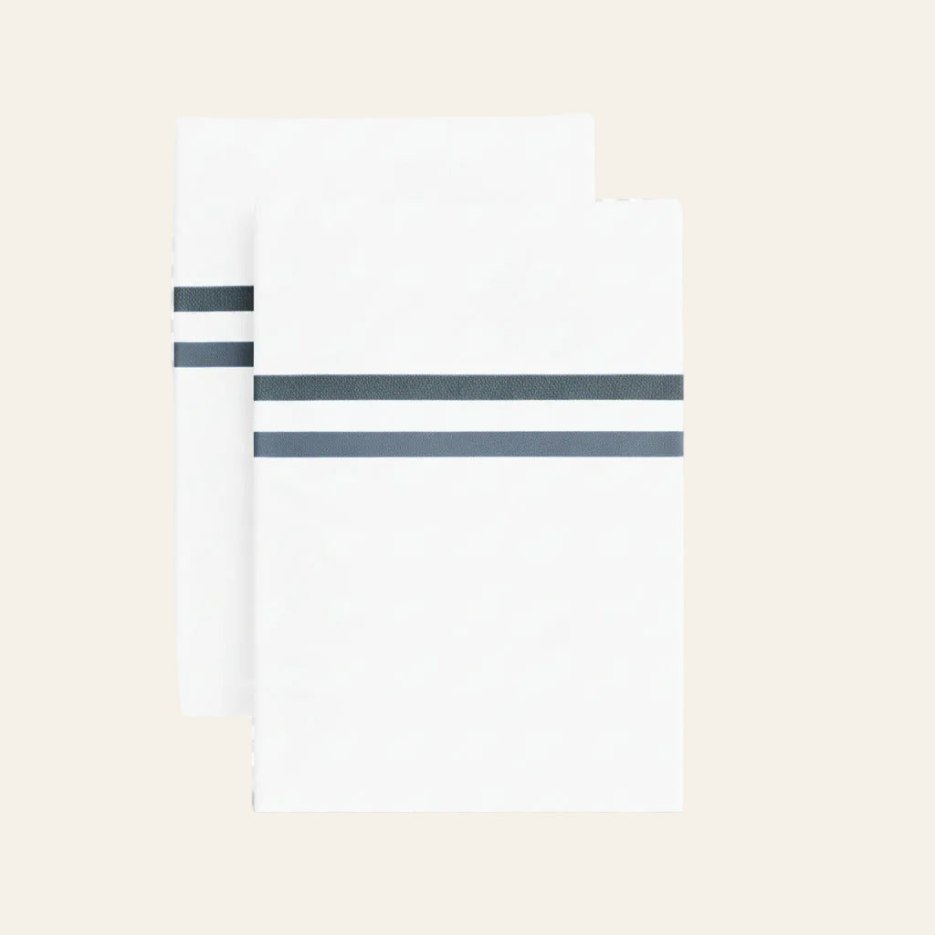 Ann Gish Doppio pillowcases in white with slate double-stripe detail, pair shown.