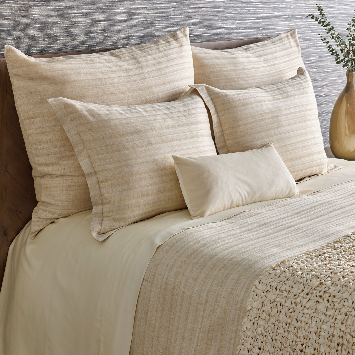 Close-up of Ann Gish Doria duvet and shams in champagne with woven stripe texture on styled bed.